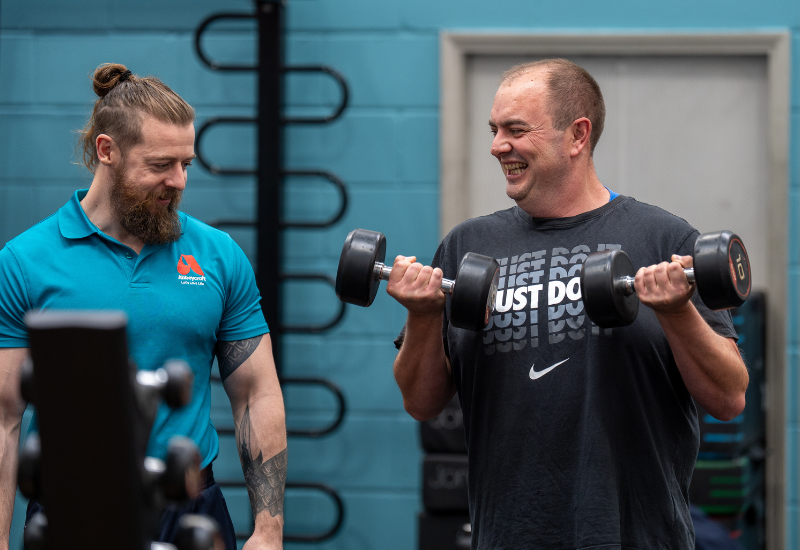 man in gym with instructor